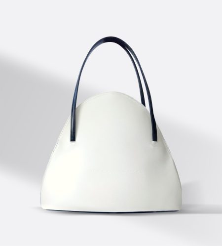 The Stefan Serval Orbalora shell-shaped shoulder and handbag, featuring a graceful curved silhouette and spacious interior crafted from premium beige calfskin.